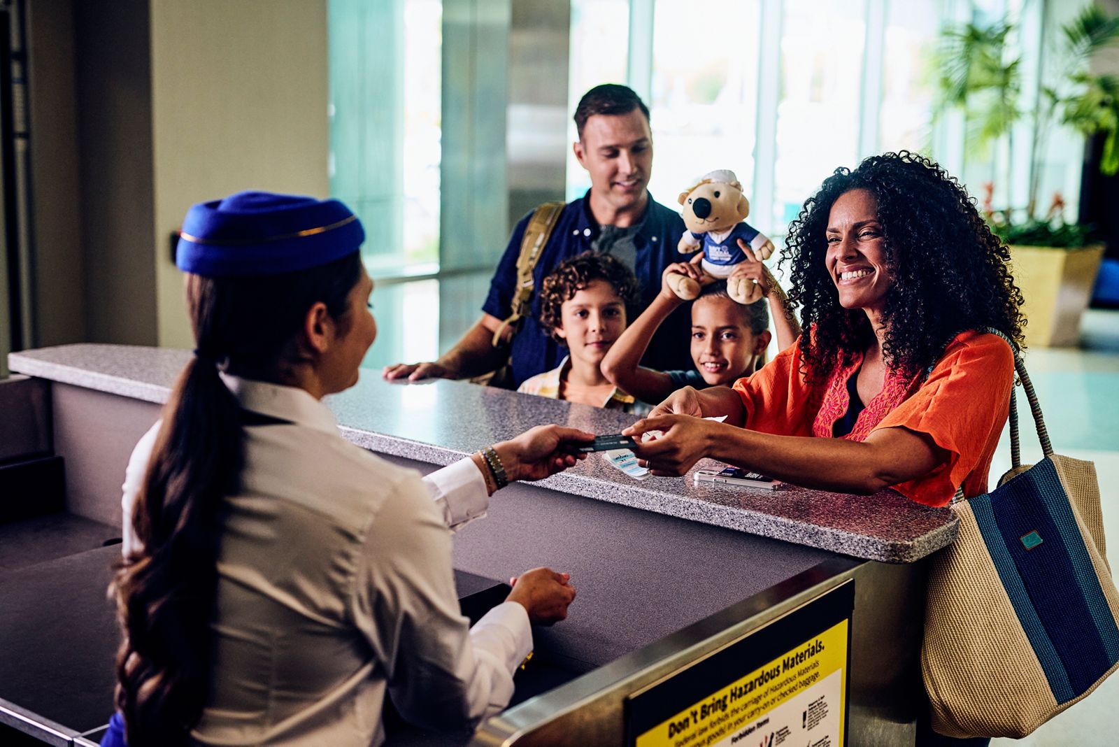 Family at the airport checking bags